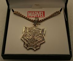 a necklace with a cat head on it in a gift box that says,'marvel '