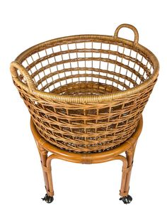 a round wicker basket sitting on top of a wooden stand with casteors and wheels