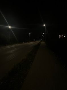 an empty road at night with street lights