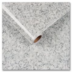 a roll of white marble paper sitting on top of a counter