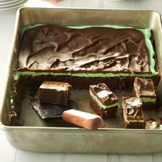 a pan filled with chocolate cake and green frosting