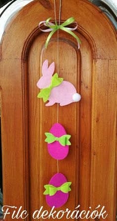 an easter decoration hanging from a wooden door