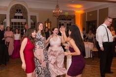 people dancing at a wedding reception in a ballroom