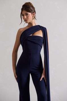 Looking for a staple jumpsuit with an added bit of drama? Look no further than Lorah. This asymmetric jumpsuit will have you reaching for it time and time again. Cut in our premium scuba crepe in a classic navy shade, Lorah boasts a flattering and elegant wide leg. With floor length sash draped down the back giving glamour, style yours with a sleek bun to let that sash do the talking.Features - Premium scuba crepe- Asymmetric neckline- Sash detail- Sleeveless- Invisible zip closure - Wide legSiz Asymmetric Jumpsuit, Red Dress Long, Red Long Sleeve Dress, Sleek Bun, Glamour Style, Asymmetric Neckline