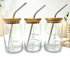 three glass mason jars with straws in them