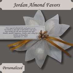 a white flower with gold accents and a poem on it that says, jordan almond favors