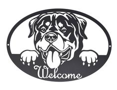 a black and white sign with a dog's face on it that says welcome