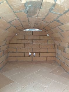 a brick oven is shown with the door open