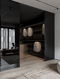 a black and white room with clothes hanging on the rack