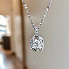 One (1) 14KT white gold cushion cut diamond halo pendant 88/100ctw. Prong set in the center with one cushion cut diamond 72/100CT of (G) color (I1) clarity GIA Certified. Diamond halo and bail is prong set around center with (38) round brilliant cut diamonds 16/100CTW of fine (G-H) color and (SI) clarity. Elegant White Radiant Cut Jewelry, Exquisite Cushion Cut Cubic Zirconia Jewelry, Moissanite Diamond Necklace With Halo Design, Cushion Cut Diamond Necklace Gift, Diamond Necklace With Halo Setting, Luxury White Cushion Cut Jewelry, Cushion Cut Lab Grown Diamond Jewelry Gift, Luxury White Diamond Necklace With Halo Setting, Dazzling Diamond Square Pendant Jewelry