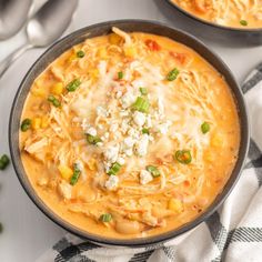 two bowls filled with soup on top of a table