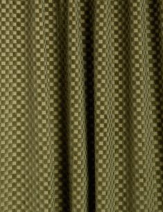 a close up view of a green checkered curtain