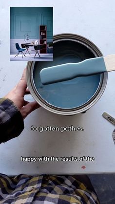 a person holding a paint can with a spatula in it and the words forgotten partners happy with the results of the painting