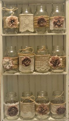 several jars with flowers and lace on them