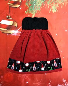 a red and black dress hanging from a christmas tree