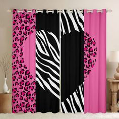 a pink and black curtain with zebra print on the side, in front of a white table