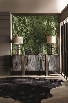 a living room with two lamps and a moss wall