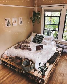 a bed made out of wooden pallets in a bedroom