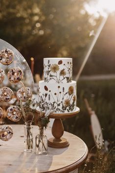 a table topped with a white cake covered in frosting