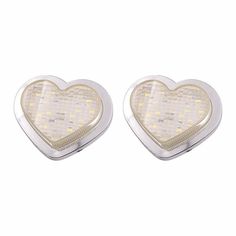 pair of heart shaped earrings with white lights in the shape of a checkerboard pattern