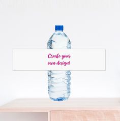 a bottle of water sitting on top of a wooden table next to a white sign