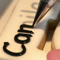 a close up of a cake with the word blog spelled in black icing on it