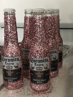 pink glitter bottles are sitting on the counter