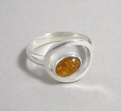 Amber and Sterling Silver Orbit Ring Handmade Modern Amber Rings, Adjustable Sterling Silver Rings In Amber, Spiritual Amber Cabochon Ring, Adjustable Sterling Silver Amber Ring, Amber Sterling Silver Oval Cabochon Ring, Bezel Jewelry, Diamond Jewelry Designs, Labradorite Ring, Natural Blue Sapphire