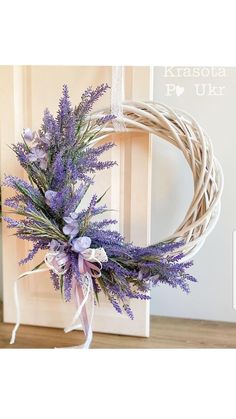 a wreath with purple flowers hanging from it