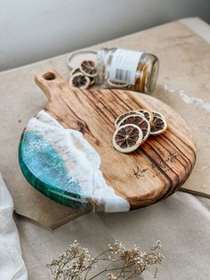 a wooden cutting board topped with sliced oranges