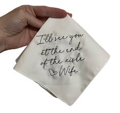 someone holding up a napkin with writing on it