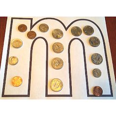 an arch made out of different coins on a white paper with black trimmings