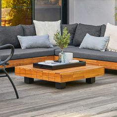 a couch and coffee table on a wooden deck