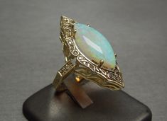 Vintage Gold Opal Cabochon Ring, Vintage Hallmarked Opal Ring For Formal Occasions, Vintage Hallmarked Opal Ring For Formal Events, Vintage Opal Gemstone Ring For Wedding, Vintage Opal Ring For Wedding, Vintage Opal Ring Gift, Vintage Style Opal Wedding Ring, Antique Gold Opal Wedding Ring, Antique Gold Opal Ring For Wedding