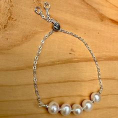 This adjustable Pearl bracelet is made with tarnish resistant silver plated wire and chain. The clasp slides to adjust up to 9 inches. The pearls are freshwater pearls and are a June birthstone. Fast free domestic shipping from Portland, Oregon. I try to ship the same or next day of your order. Your item will arrive in a gift box with bow and my shop name suitable for gift giving. I am happy to send it directly to your gift recipient and include a card with your special message. Just mention it in your buyers notes when you order. You can follow me on Instagram @banbajewelry Pinterest @banba3 Adjustable Sterling Silver Pearl Charm Bracelet, Adjustable Hypoallergenic Pearl Bracelet For Anniversary, Adjustable Nickel-free Pearl Bracelet For Gift, Adjustable Sterling Silver Pearl Drop Bracelet, Adjustable Pearl Bracelet For Anniversary, Adjustable Pearl Chain Bracelet For Anniversary, Adjustable Silver Pearl Bracelet Gift, Adjustable Sterling Silver Pearl Bracelet Nickel Free, Adjustable Silver Pearl Bracelets