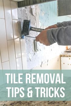 a person using a hammer to remove tiles and bricks from a wall with the words tile removal tips & tricks on it