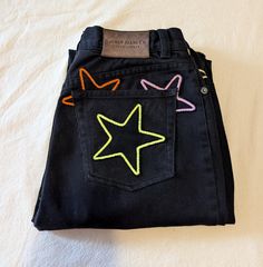 Reworked vintage black high-rise jeans. These jeans are reworked with handmade black denim star patches in an autumnal color pallate of yellow, orange and neon green. All pockets are fully functional. Original jeans are by Lauren Jeans Co. 100% cotton, made in Hong Kong. Marked a size 6P- 27" waist, 11" rise, 38" hips, 27" inseam, 13" leg opening. In great vintage condition with some very light vintage wear. Patchwork Star, Reworked Clothes, Star Patches, Reworked Clothing, Clothing Upcycle, Autumn School Outfit, Reworked Vintage, Star Jeans, Recycled Denim