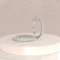 ✥ Discover elegance and sophistication with our Round Pave CZ Hoop Diamond Earrings for Women, crafted in solid gold. These exquisite earrings feature a dazzling array of pave-set cubic zirconia stones, meticulously placed to radiate brilliance from every angle. Perfect for any occasion, whether it's a glamorous evening out or adding a touch of sparkle to your everyday ensemble. The solid gold setting ensures durability and timeless appeal, making them a cherished addition to your jewelry collection. Elevate your style effortlessly with these hoop earrings that combine classic design with modern glamour, promising to enhance your natural beauty with their shimmering allure.✦ Main Stone Details✧ Type: Stud Earrings✧ Shape: Round Cut✧ Stone Size: 5.5ctw ✧ Width: 6.0 mm✧ Moissanite Details: D Hoop Diamond Earrings, Diamond Earrings For Women, Daily Wear Jewellery, Hoop Design, Diamond Hoop Earrings, Engagement Ring Wedding Band, 2 Carat, Gold Set, Moissanite Diamonds