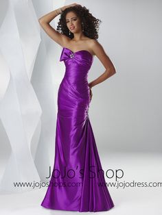 a woman in a purple dress posing for the camera