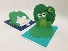 two cards with frog and flower on them, one is folded to look like an apple