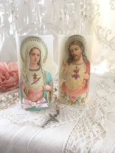 "Beautiful pair of Victorian inspired Jesus and Mary flameless candles adorned with sparkling German glass glitter, pearl adornments and pink satin bows. The pastel coloring is perfect for shabby cottage chic style decorating! That's adorable pair would look lovely displayed on a mantle, alter, shrine or makes a sweet devotional gift. Made of white wax...The lightweight candles have a realistic shaped design at the top, these are really good quality. Battery operated candles are a safe alternati Church Aesthetic, Jesus And Mary, Catholic Crafts, German Glass Glitter, Burning Candles, Glass Glitter, Prayer Candles, Battery Operated Candles, White Wax