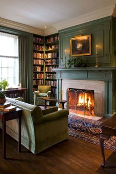 a living room filled with furniture and a fire place in front of a book shelf