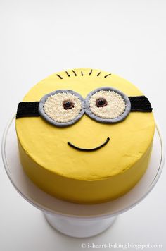 a yellow cake with a smiley face and glasses on it