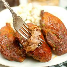 a fork is stuck into some meat on a plate