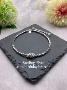 "*ITEM DESCRIPTION* This lovely beaded bracelet is made using 3mm sterling silver beads, with 4 fine silver circle charms with each circle representing each decade. Each bracelet has a sterling silver 925 tag attached.  This bracelet is also available with 3, 5 or 6 circle charms. Please see separate listings below.  30th birthday bracelet  https://etsy.me/2pyRTOe  50th birthday bracelet  https://etsy.me/2HmKY4Q 60th birthday bracelet  https://etsy.me/2t7MoYr  There is a choice of silver or gold 40th Birthday Gift For Women, 40th Birthday Gifts For Women, 50th Birthday Gifts For Woman, 40 Birthday, Cute Friendship Bracelets, Women Friendship, Happy 40th Birthday, Birthday Bracelet, Circle Bracelet