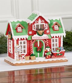 a red and green christmas house with decorations