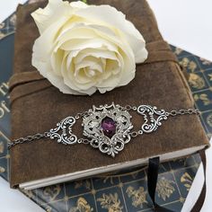 This unique Amethyst bracelet is made with sterling silver plated brass vintage stampings that form a gothic/fantasy look. The center 16x11mm stone is a vintage Swarovski crystal (no longer in production). The bracelet measures 2" tall and 7.5" long, which will fit most women's wrists. I offer two options for the closure:1. A steel slider chain that is easy to adjust and secure.2. A sterling silver plated brass cable chain with a lobster claw closure. If you need longer chain, then please let me Fantasy Bracelet, Fantasy Look, Jewelry Gothic, Vintage Gothic, Amethyst Bracelet, Bracelet Vintage, Gothic Jewelry, Long Chain, Amethyst Crystal