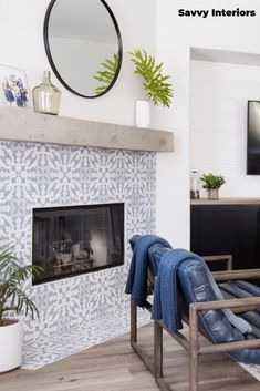 a living room with a fire place and a mirror on the wall next to it