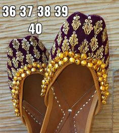 a pair of purple and gold shoes with golden beads on the soles for sale