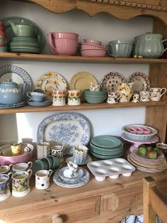 a shelf filled with lots of plates and bowls